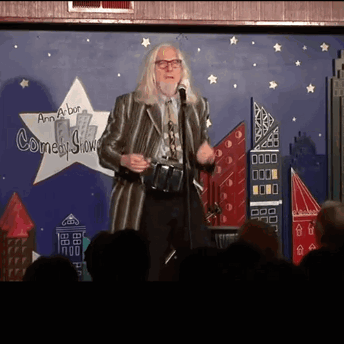 Man Standing In Front Of Comedy Show Sign GIF