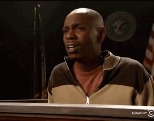 Man Standing In Front Of Comedy Sign GIF