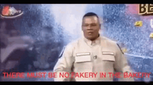 Man Standing in Front of Crowd Sign No Fakery in the Bakery