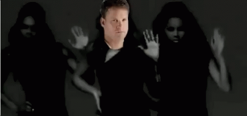 Man Standing in Front of Dancing Women Black and White Photo