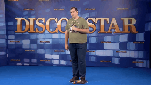 Man Standing in Front of Disco Star Banner