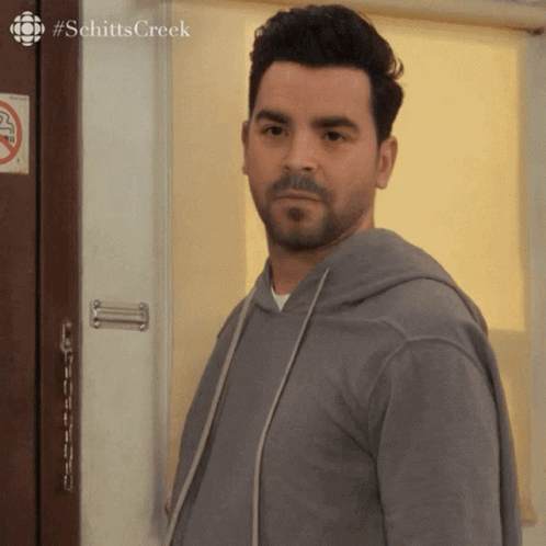 Man Standing in Front of Door with Schitts Creek
