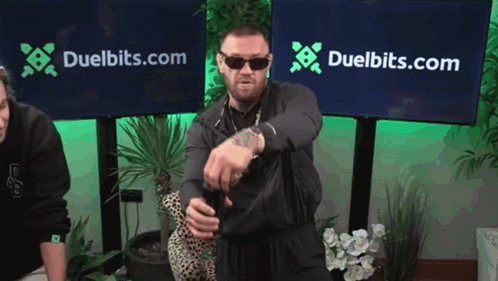 Man Standing in Front of Duelbits Banner