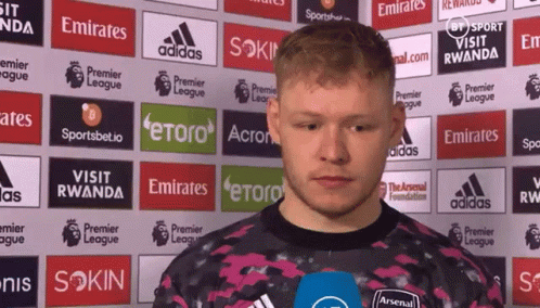 Man Standing in Front of Emirates Ads