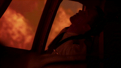 Man Standing in Front of Fire in Dark Room