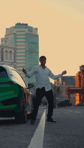 Man Standing in Front of Green Car