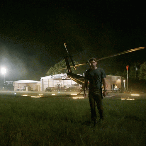 Man Standing in Front of Helicopter