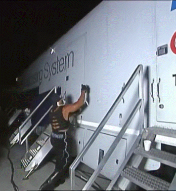 Man Standing in Front of Housing System Trailer