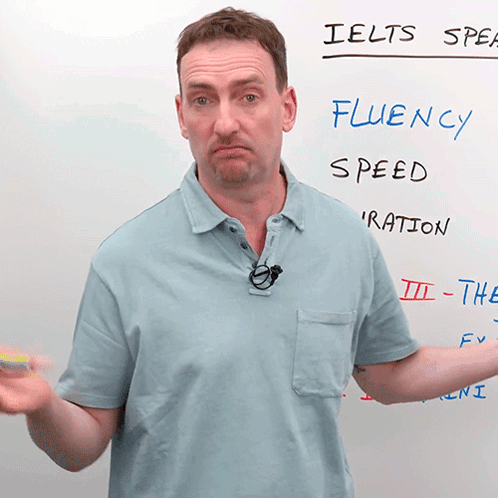 Man Standing in Front of IELTS Speak Whiteboard