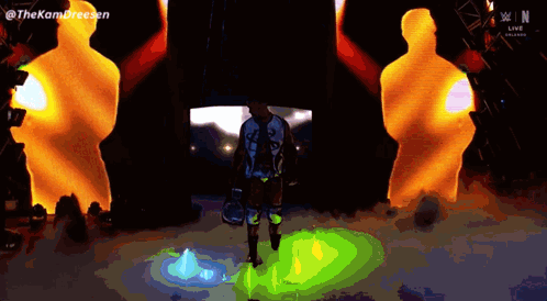 Man Standing In Front Of Kom Dreesen Screen GIF