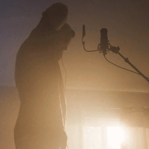 Man Standing in Front of Microphone