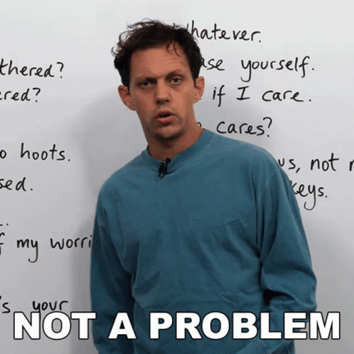 Man Standing in Front of Not a Problem Whiteboard