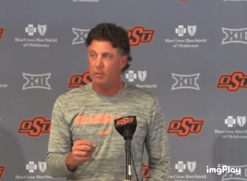 Man Standing In Front Of OSU Wall GIF
