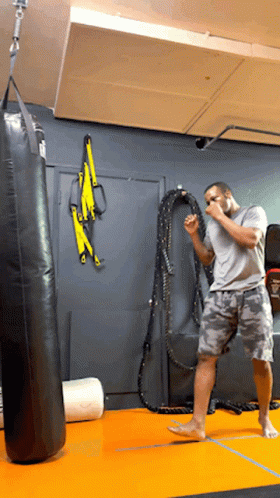 Man Standing in Front of Punching Bag
