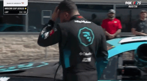 Man Standing in Front of Race Car With Fox 75 Logo