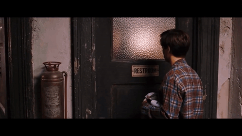 Man Standing In Front Of Restroom Door GIF