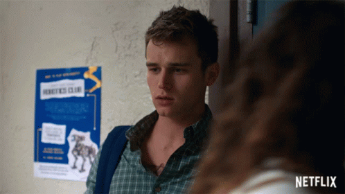 Man Standing in Front of Robotics Club Sign