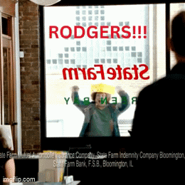 Man Standing in Front of Rodgers Sign