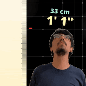 Man Standing In Front Of Ruler Reading 33 Cm GIF