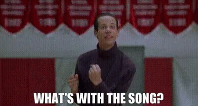 Man Standing In Front Of Sign What's With The Song GIF
