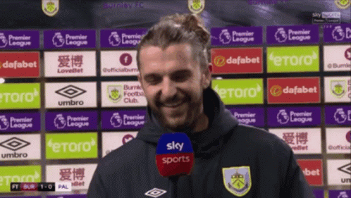 Man Standing in Front of Sky Sports Ads
