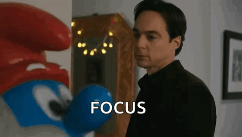 Man Standing in Front of Smurf Saying Focus