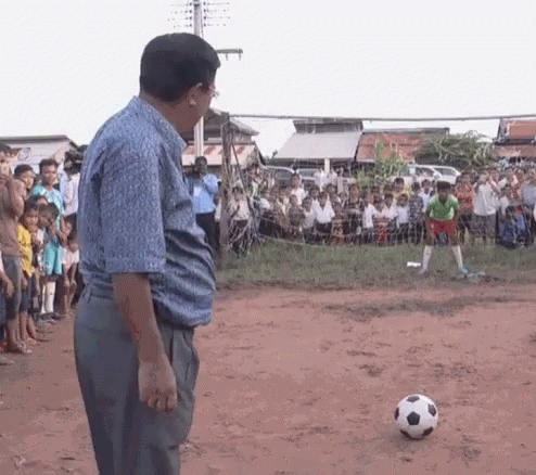 Man Standing in Front of Soccer Ball