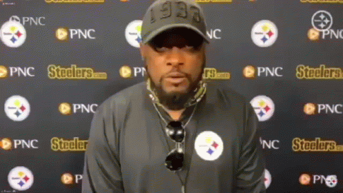 Man Standing in Front of Steelers Wall