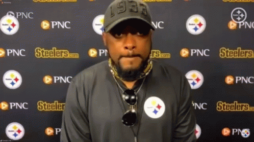 Man Standing in Front of Steelers Wall