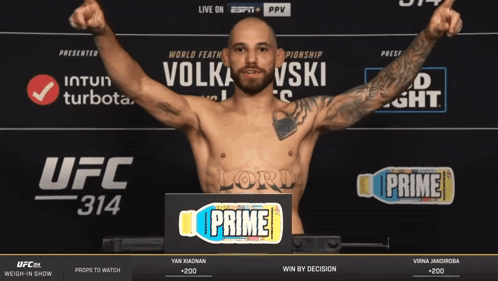Man Standing in Front of UFC 314 Sign