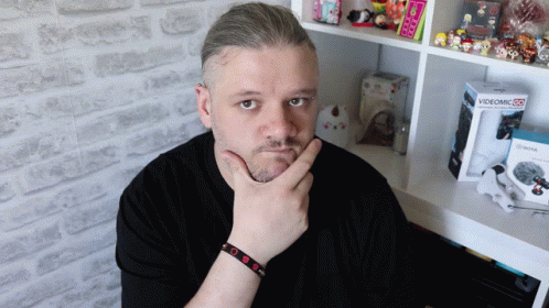 Man Standing In Front Of Videomic 25 Box GIF