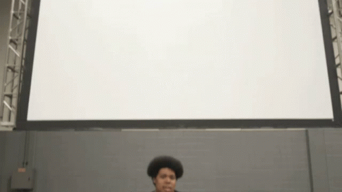 Man Standing In Front Of White Screen GIF