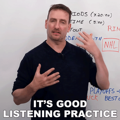 Man Standing in Front of Whiteboard Saying Listening Practice