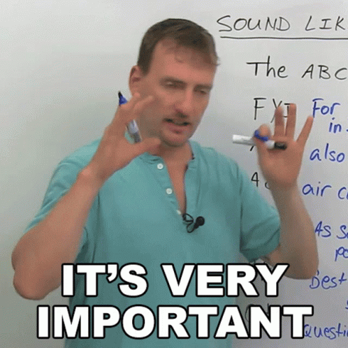 Man Standing in Front of Whiteboard with Important Words