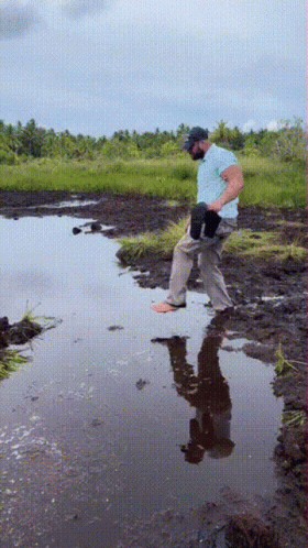 Man Standing In Puddle With Reflection GIF