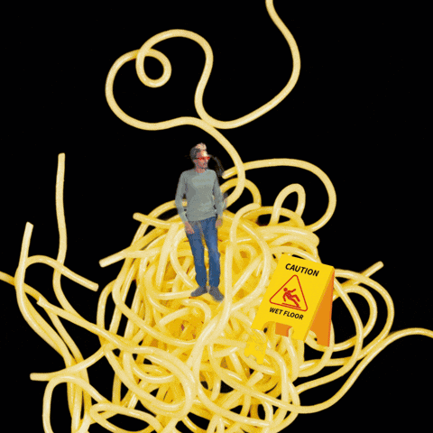 Man Standing In Spaghetti With Wet Floor Sign GIF
