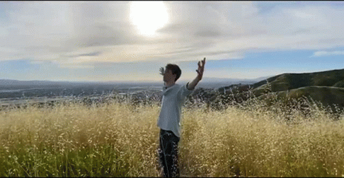 Man Standing in Tall Grass Field