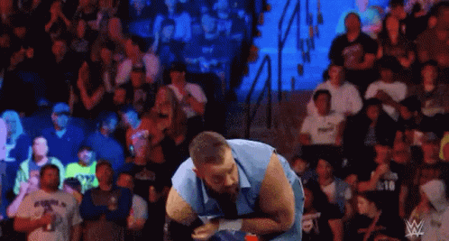 Man Standing in Wrestling Ring Facing Crowd