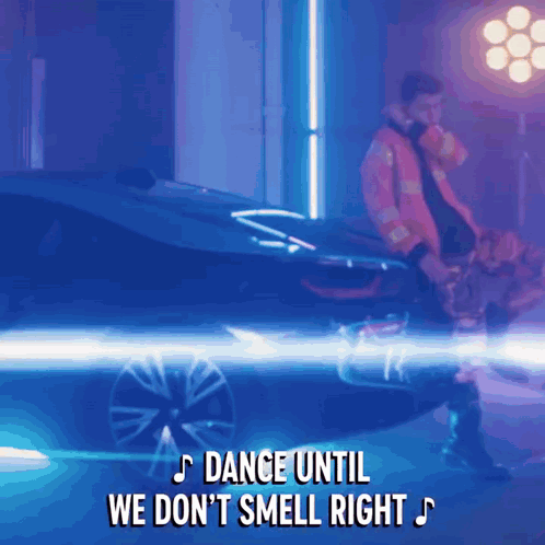 Man Standing Next to Car Dance Until We Don't Smell Right