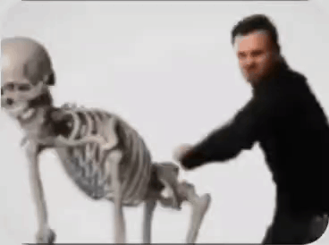 Man Standing Next to Crawling Skeleton