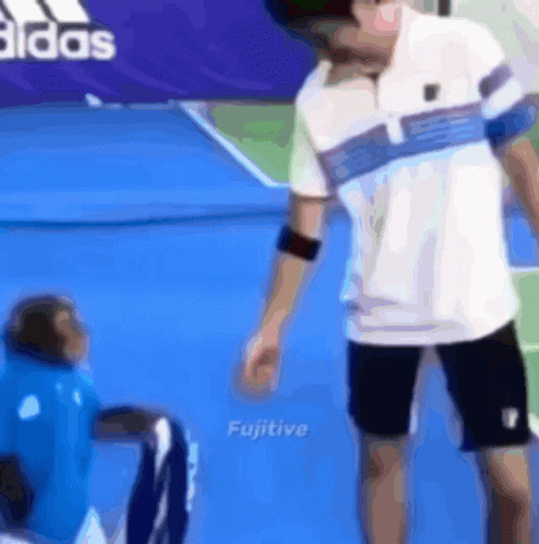 Man Standing Next to Monkey on Tennis Court