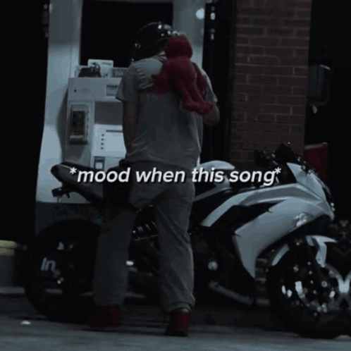 Man Standing Next to Motorcycle With Mood When This Song