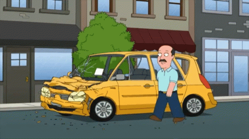 Man Standing Next to Smashed Car