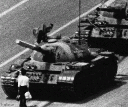 Man Standing Next to Tank