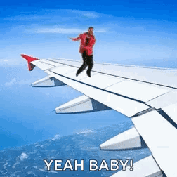 Man Standing on Airplane Wing Saying Yeah Baby