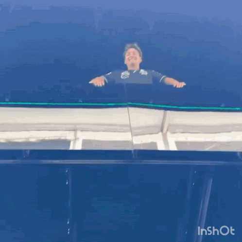 Man Standing on Balcony with Blue Sky