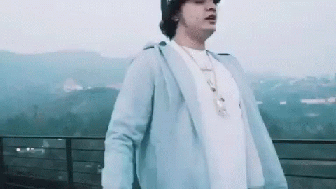 Man Standing on Balcony with Mountains