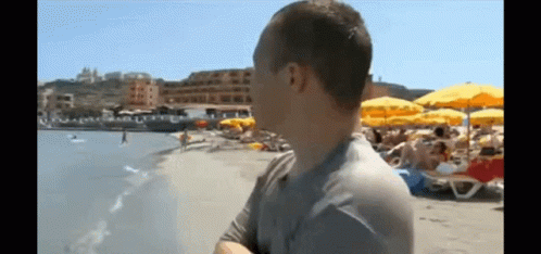 Man Standing On Beach Looking At Ocean GIF
