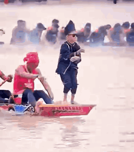 Man Standing On Boat As People Row GIF