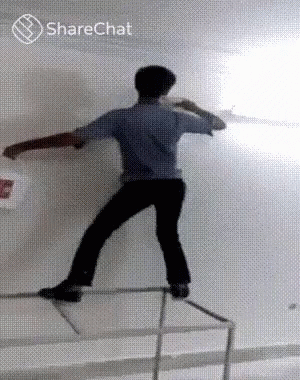 Man Standing on Railing with Bucket